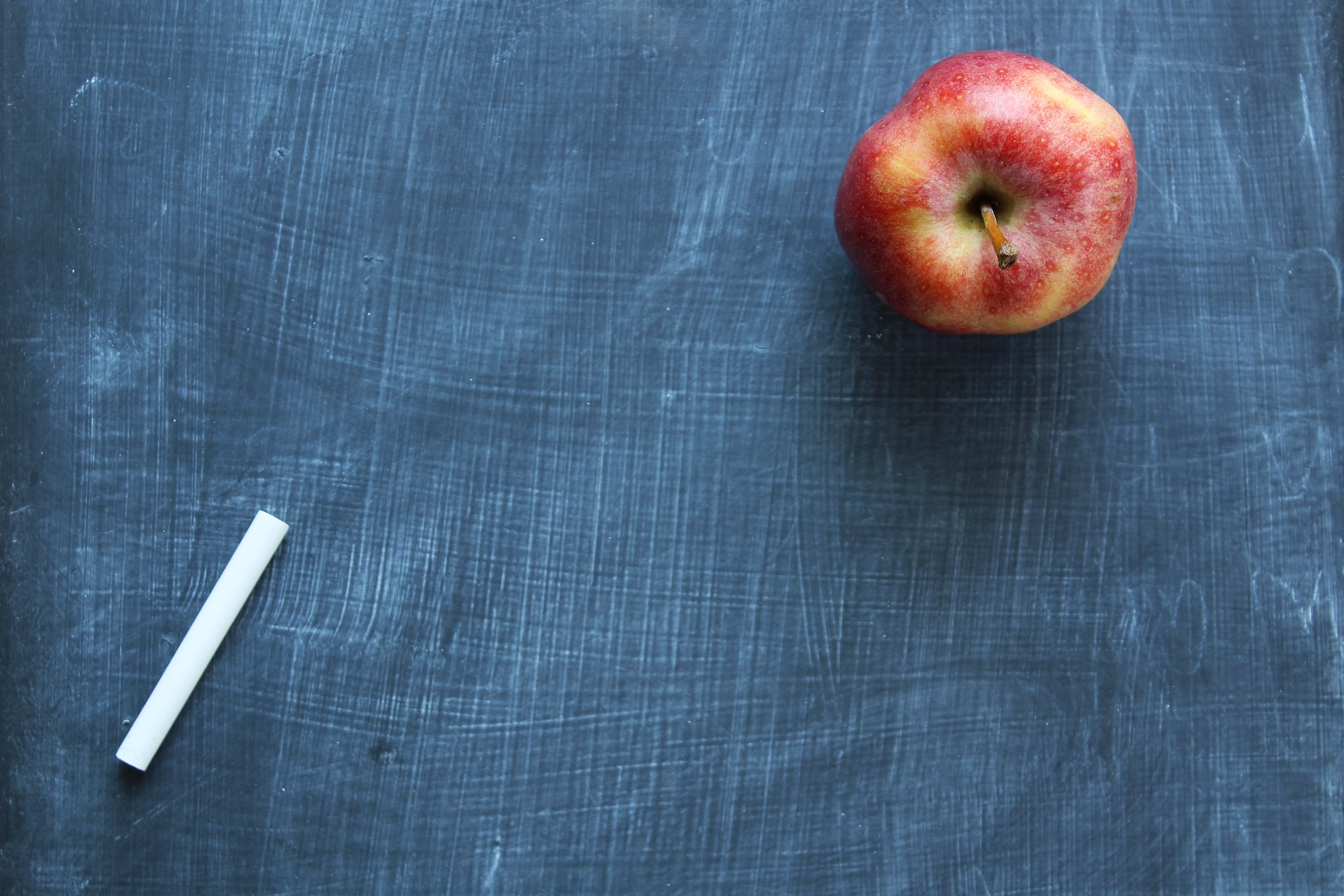 Chalkboard with chalk and apple