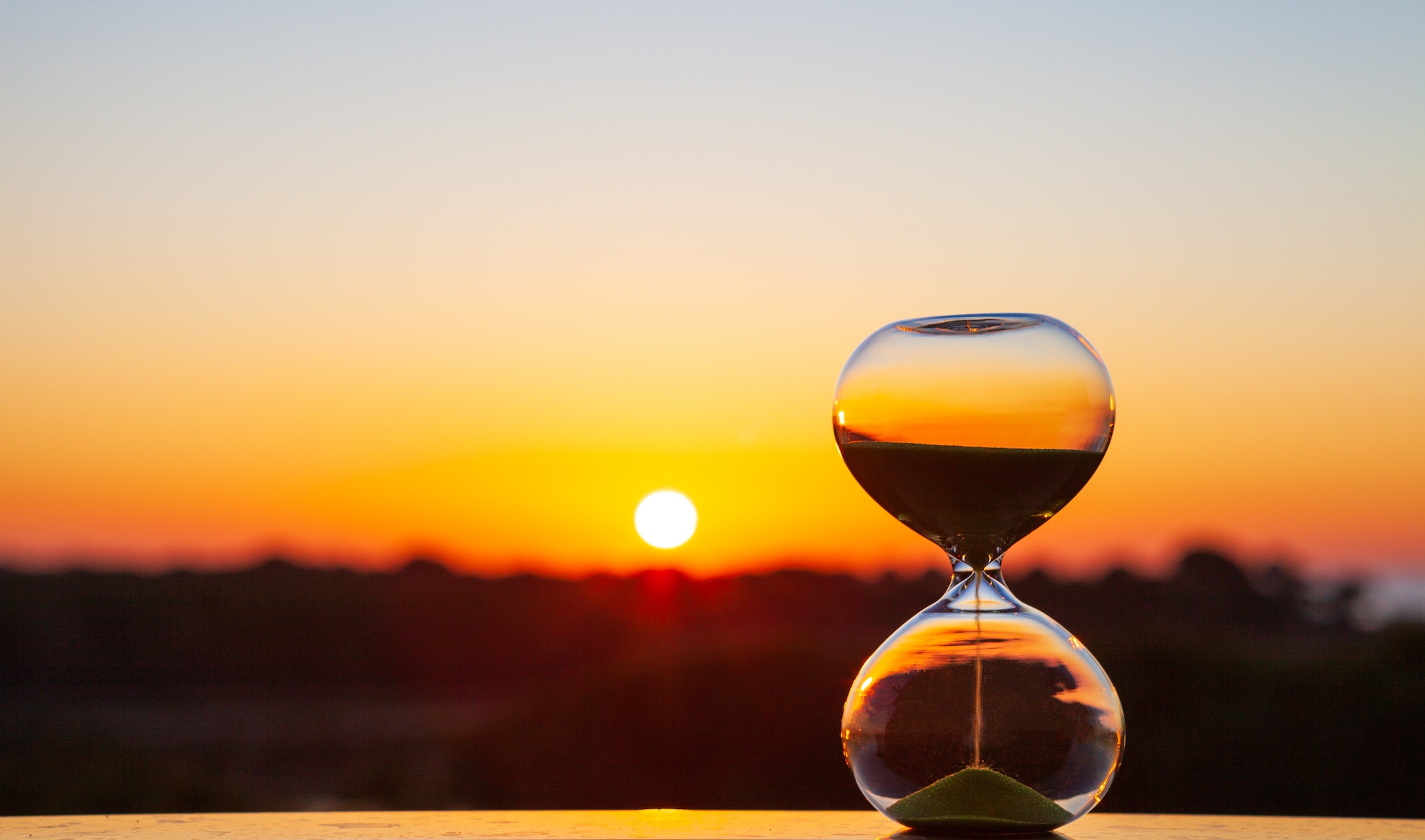 An hourglass at sunset